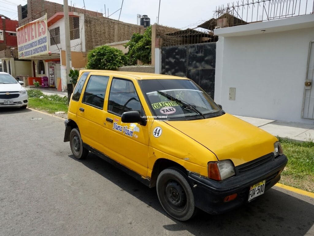 Ica bus terminal exit area with local yellow Tico taxis