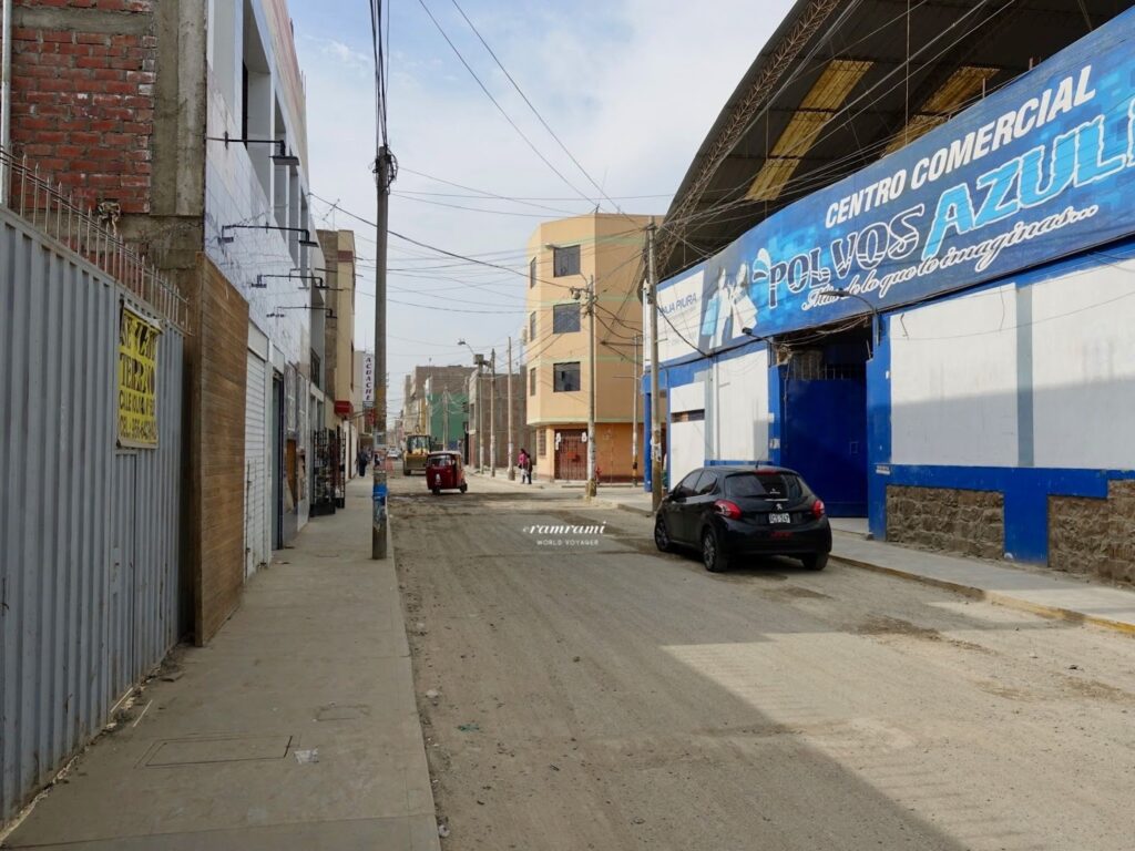 Traveler keeping backpack secure while walking in Ica