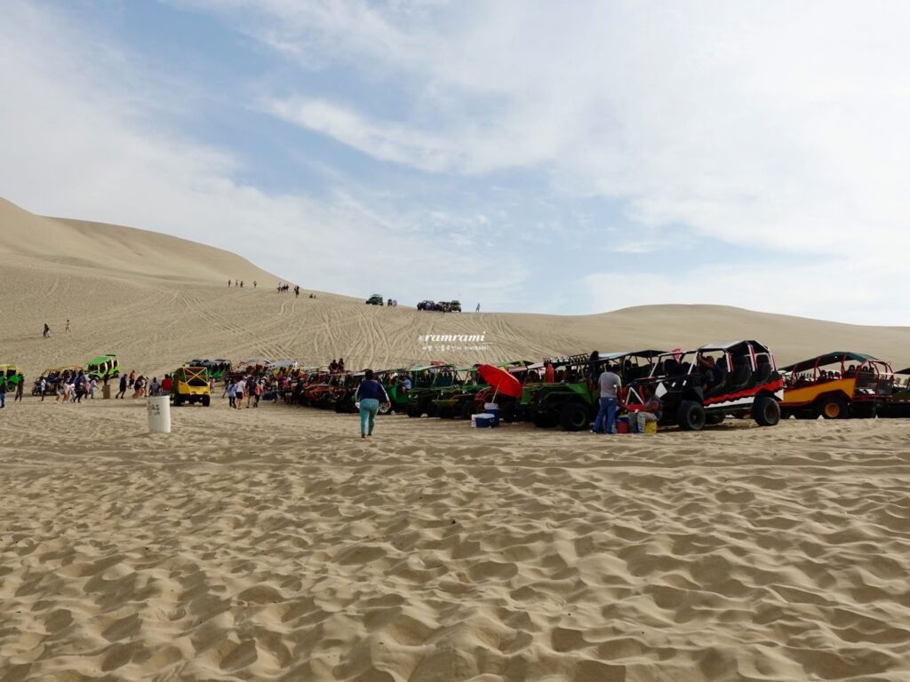 imageRows of colorful dune buggies in Huacachina desert Peru