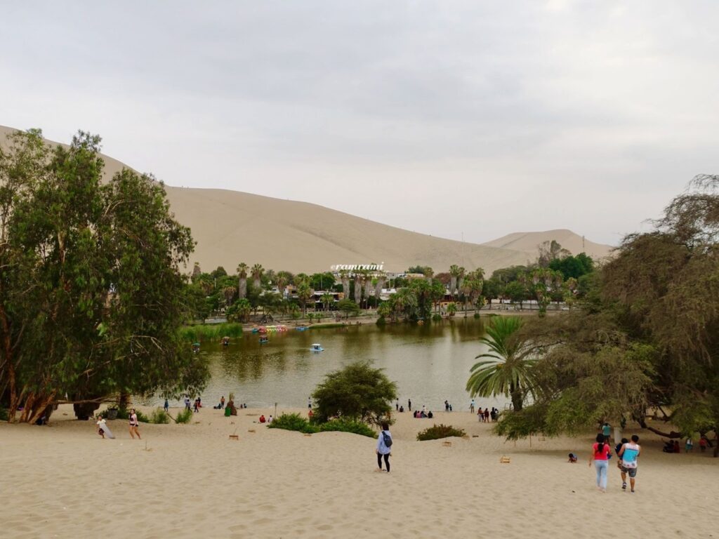 Panoramic view of Huacachina lagoon from the sand ridge