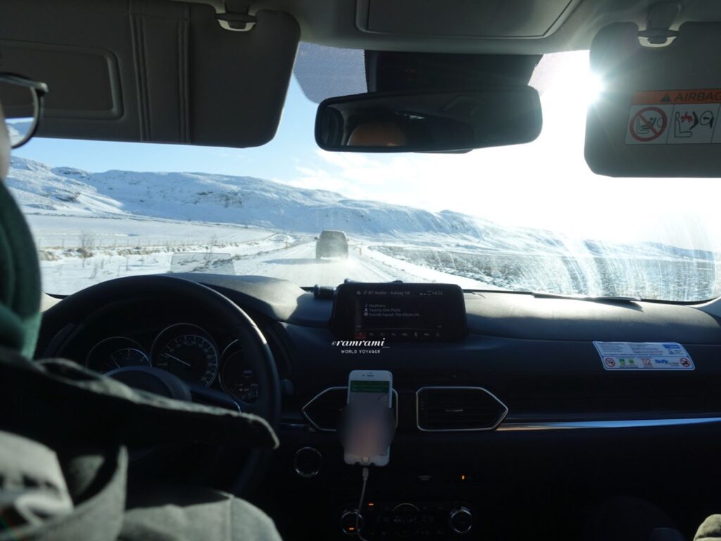 Iceland winter driving inside car on snowy Ring Road with low visibility
