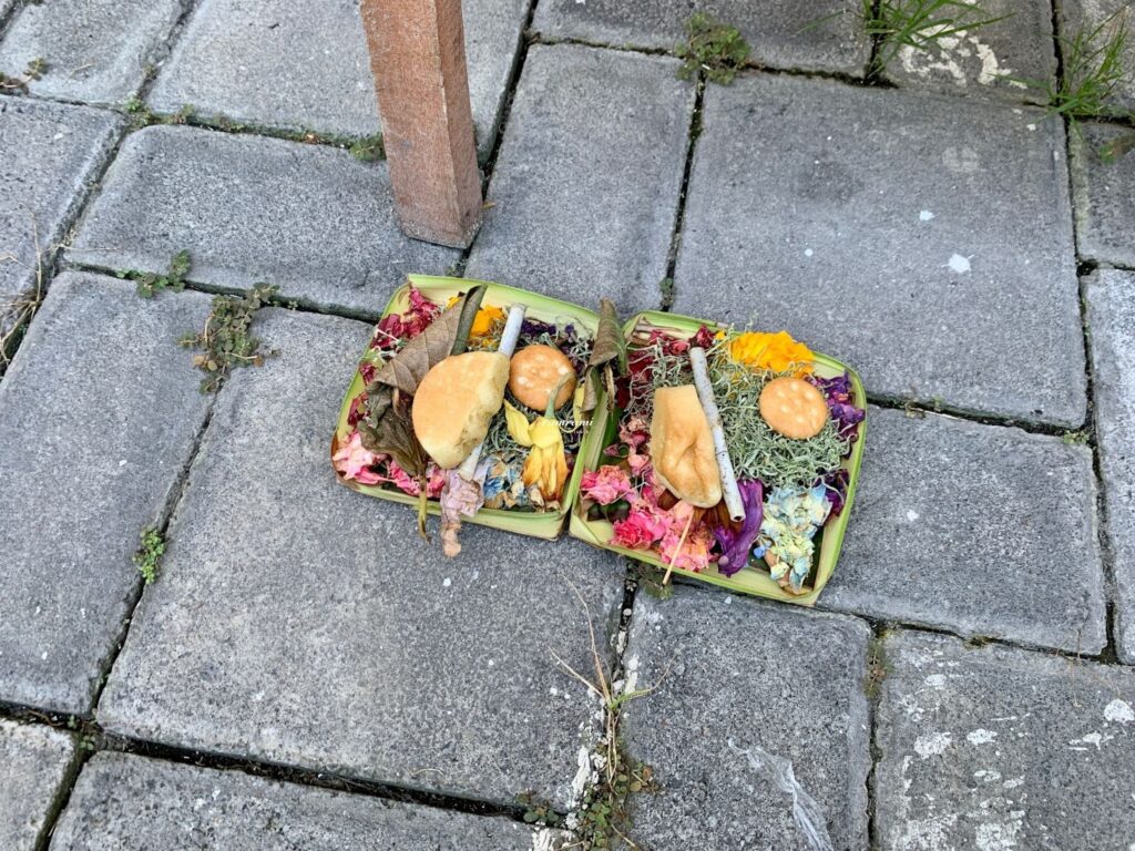 Fresh Canang Sari with incense and food offerings in Bali