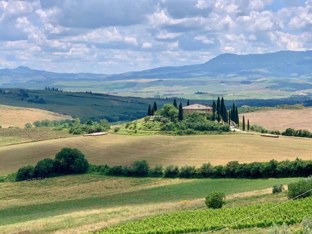 Rolling hills and farmhouse in Val d'Orcia Tuscany
