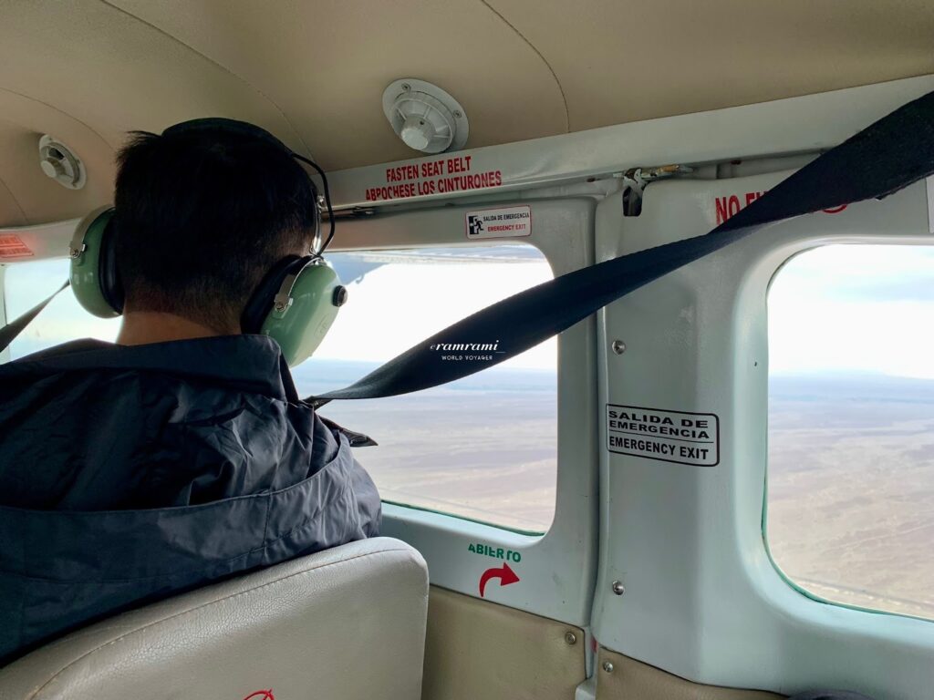 Inside cabin view during Nazca Lines flight showing desert landscape below