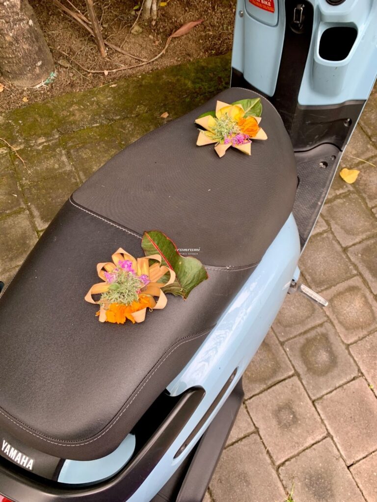 Canang Sari placed on motorbike seat in Bali for safety blessing